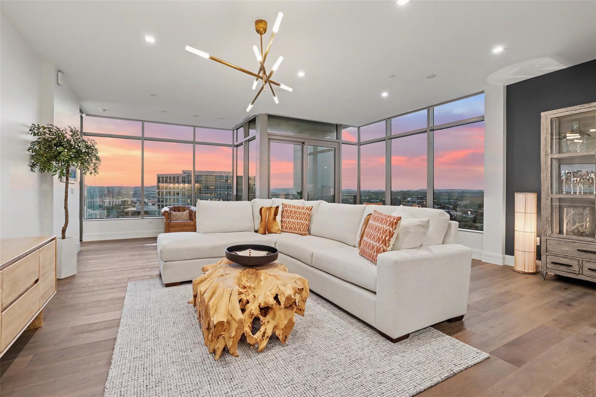 Floor-to-ceiling windows frame expansive city vie