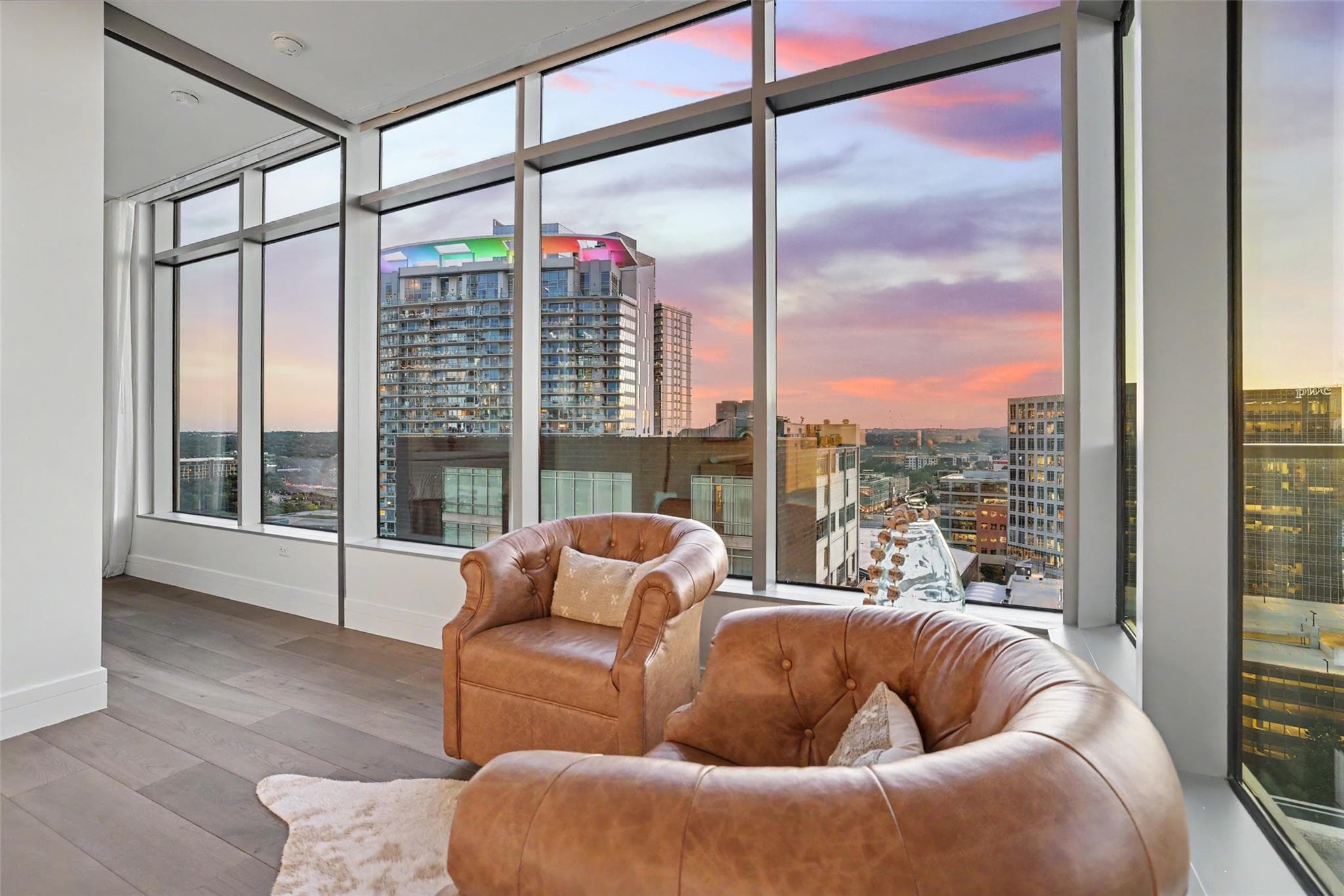 Floor-to-ceiling windows present a commanding cit