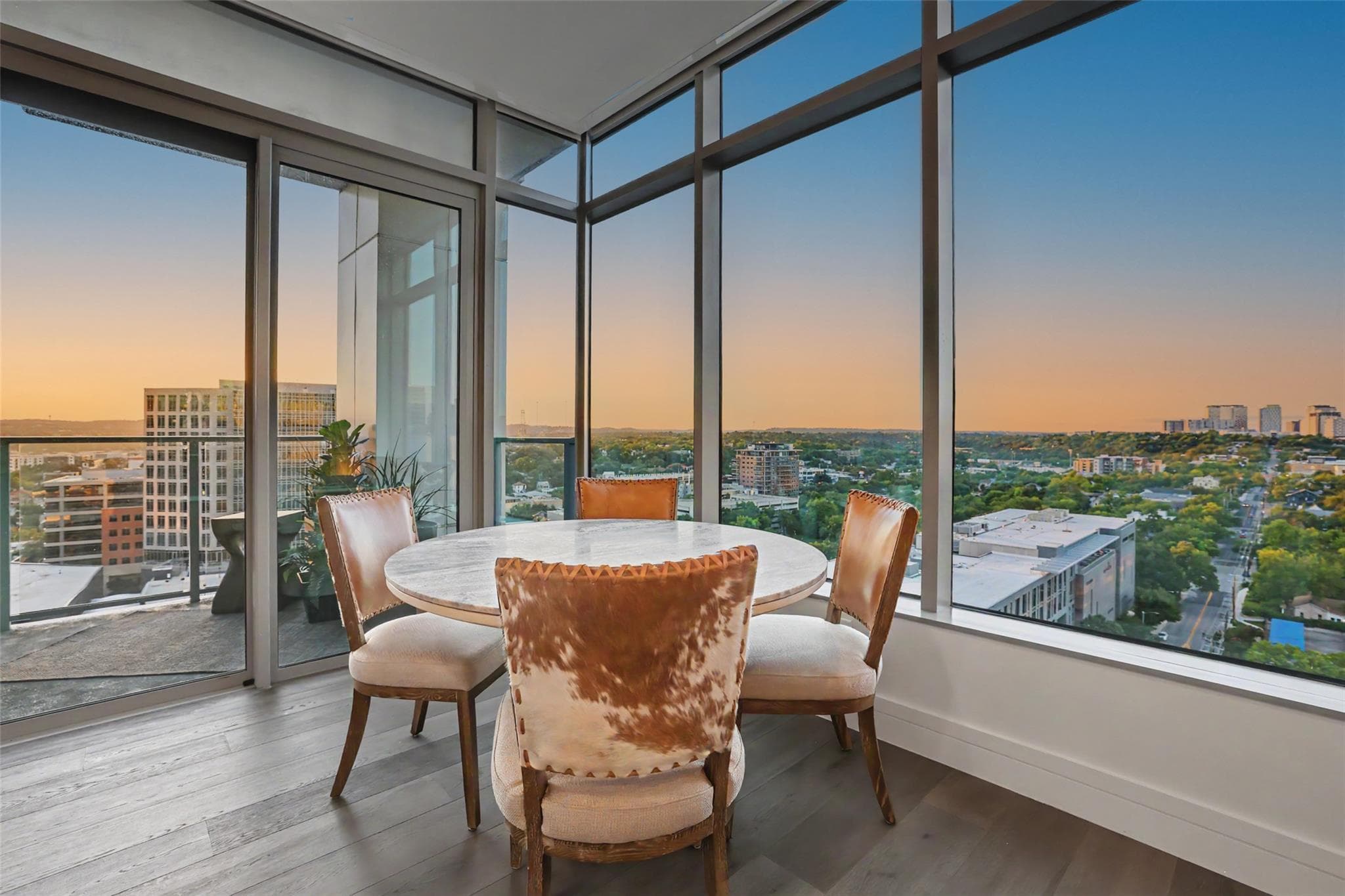 Floor-to-ceiling windows frame sweeping city vist