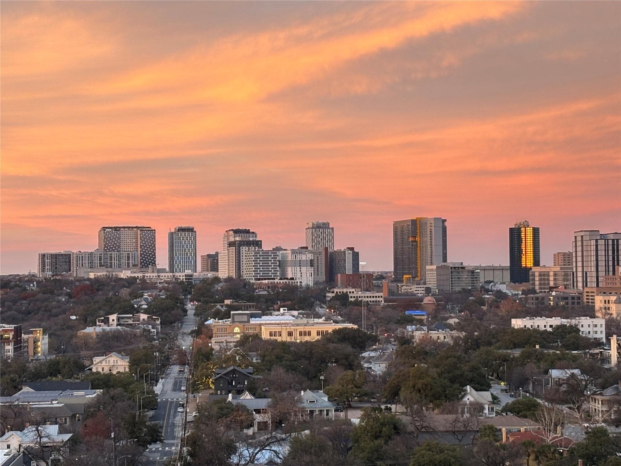 Witness the dramatic skyline at dusk, bathed in t