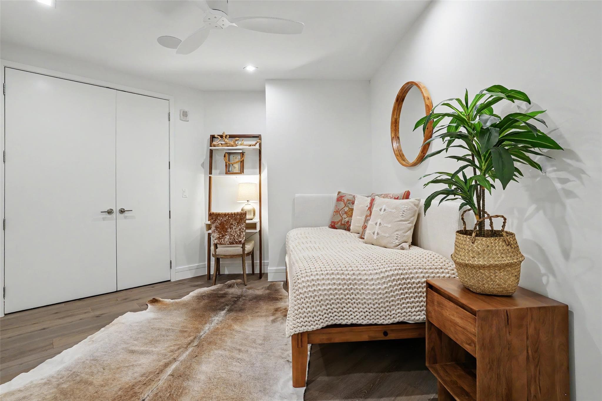 Well-lit room featuring hardwood flooring and a f