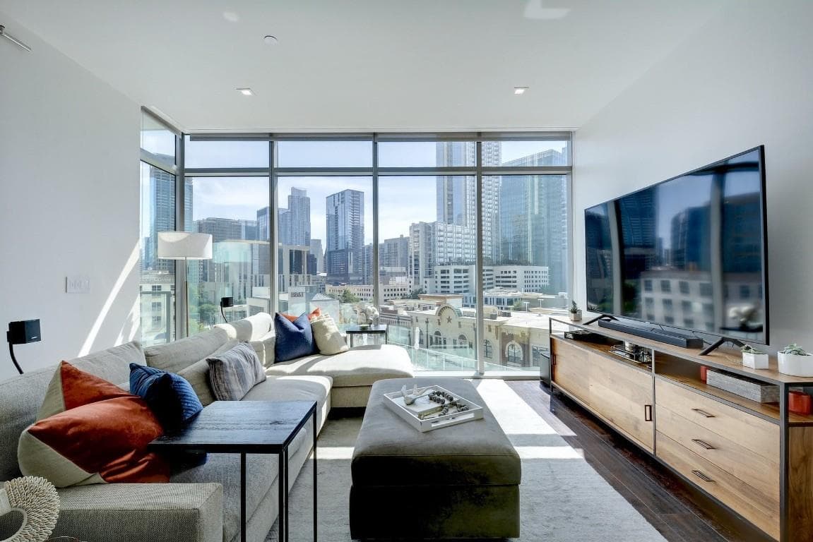 Living room with expansive windows and dark wood