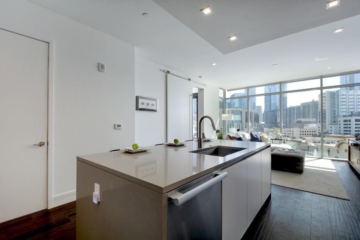Kitchen with a kitchen island with sink, dark woo