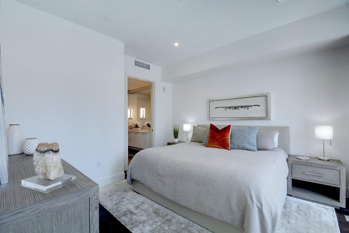 Carpeted bedroom with ensuite bathroom and recess