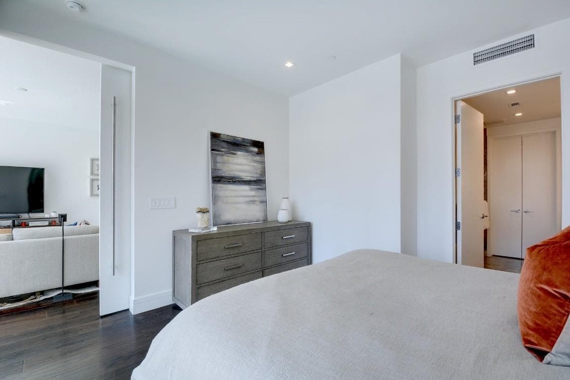 Bedroom featuring dark wood-style flooring and re