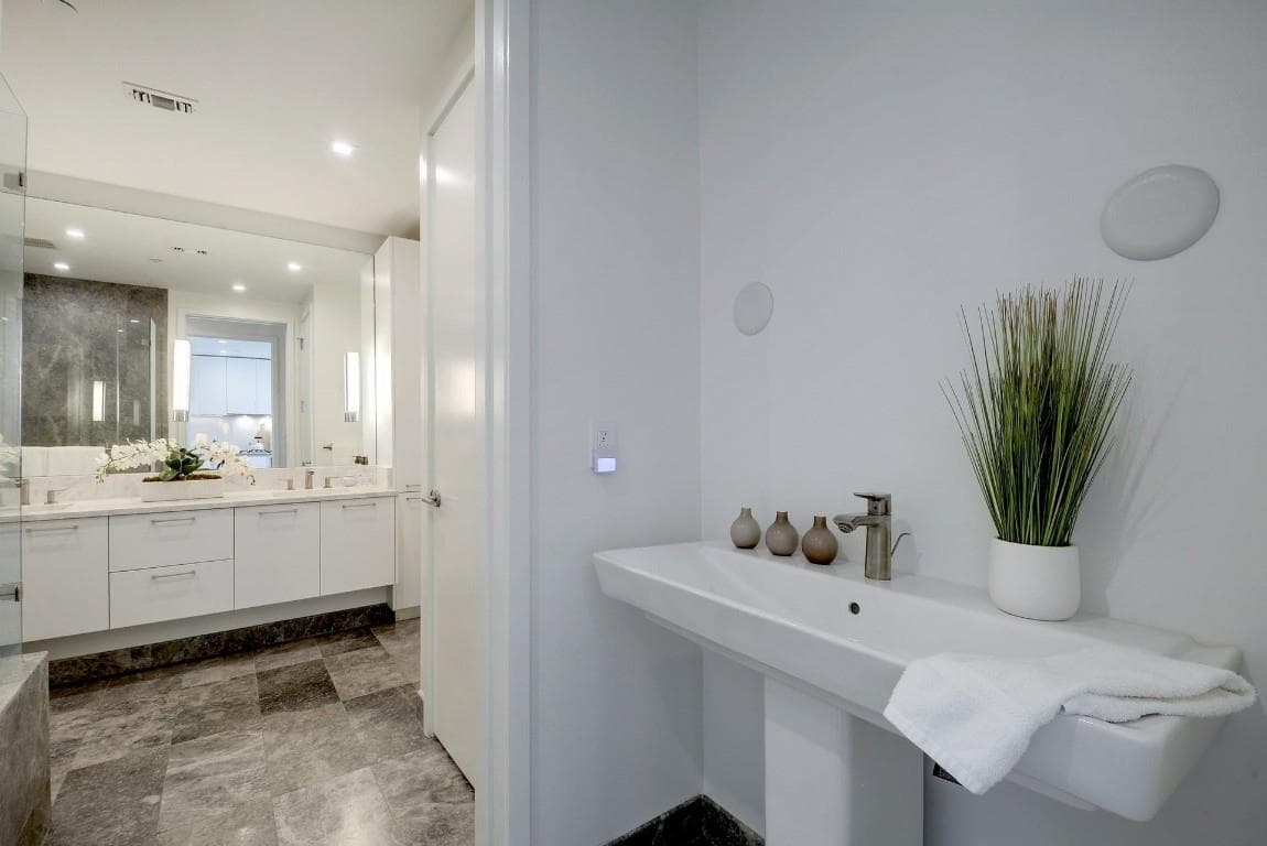 Full bathroom with vanity, stone finish floors, a