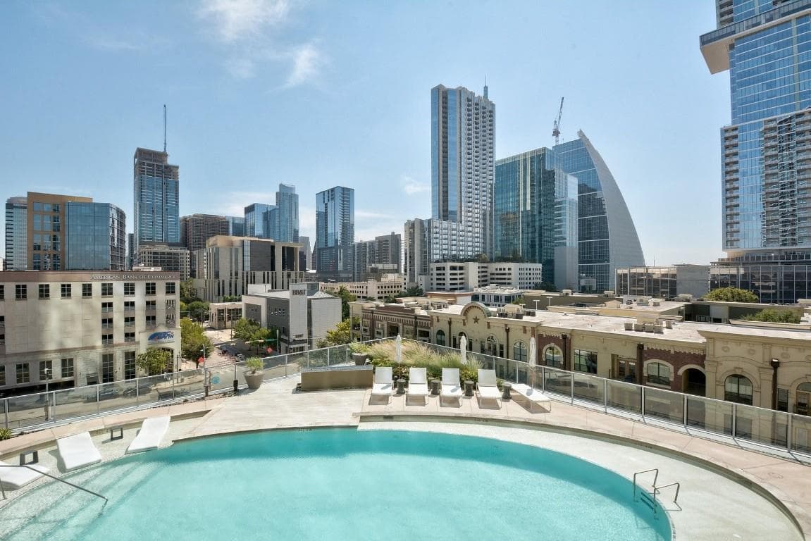 Community pool featuring a patio area and a view