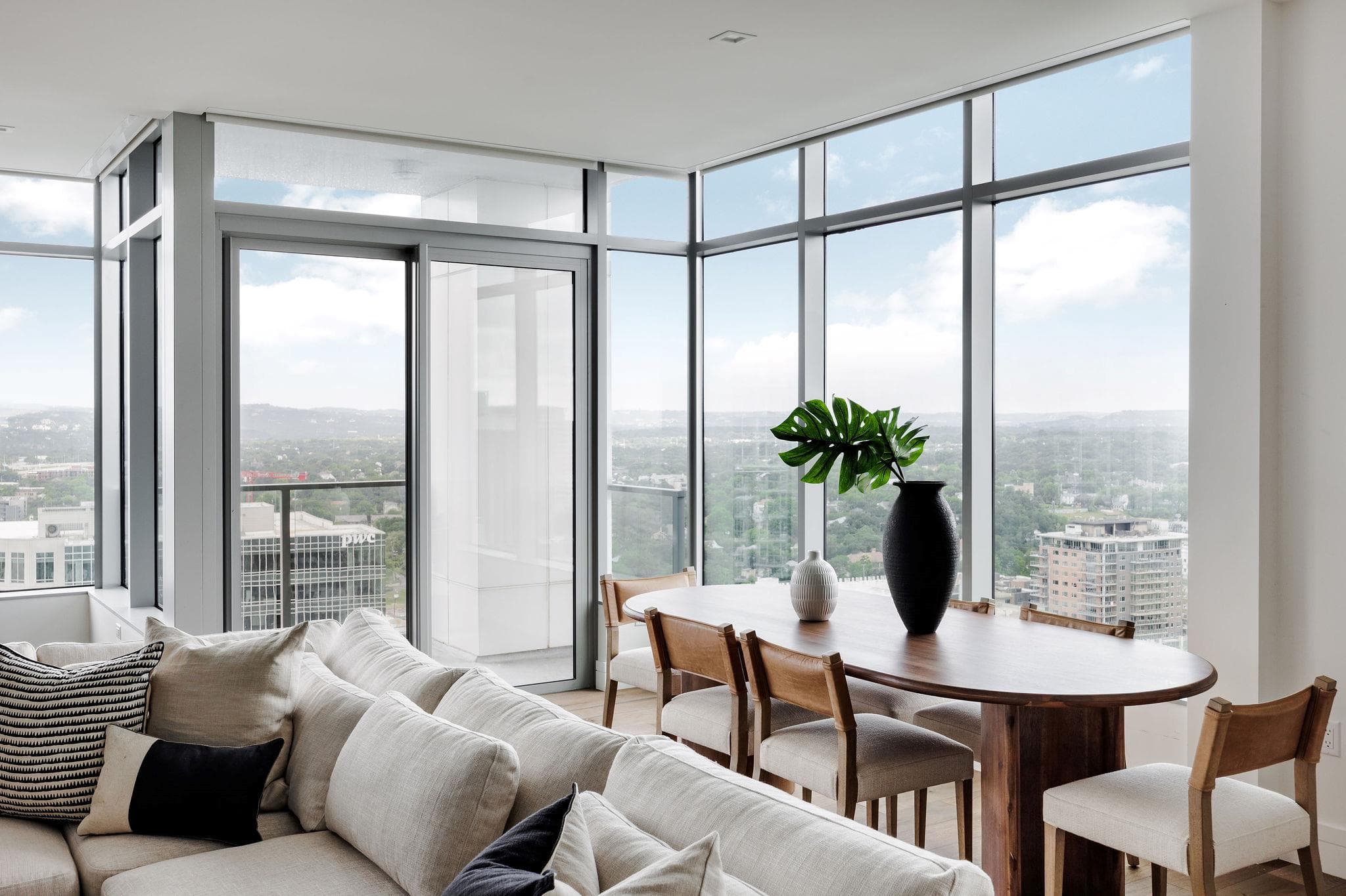 Floor-to-ceiling windows frame a panoramic city v