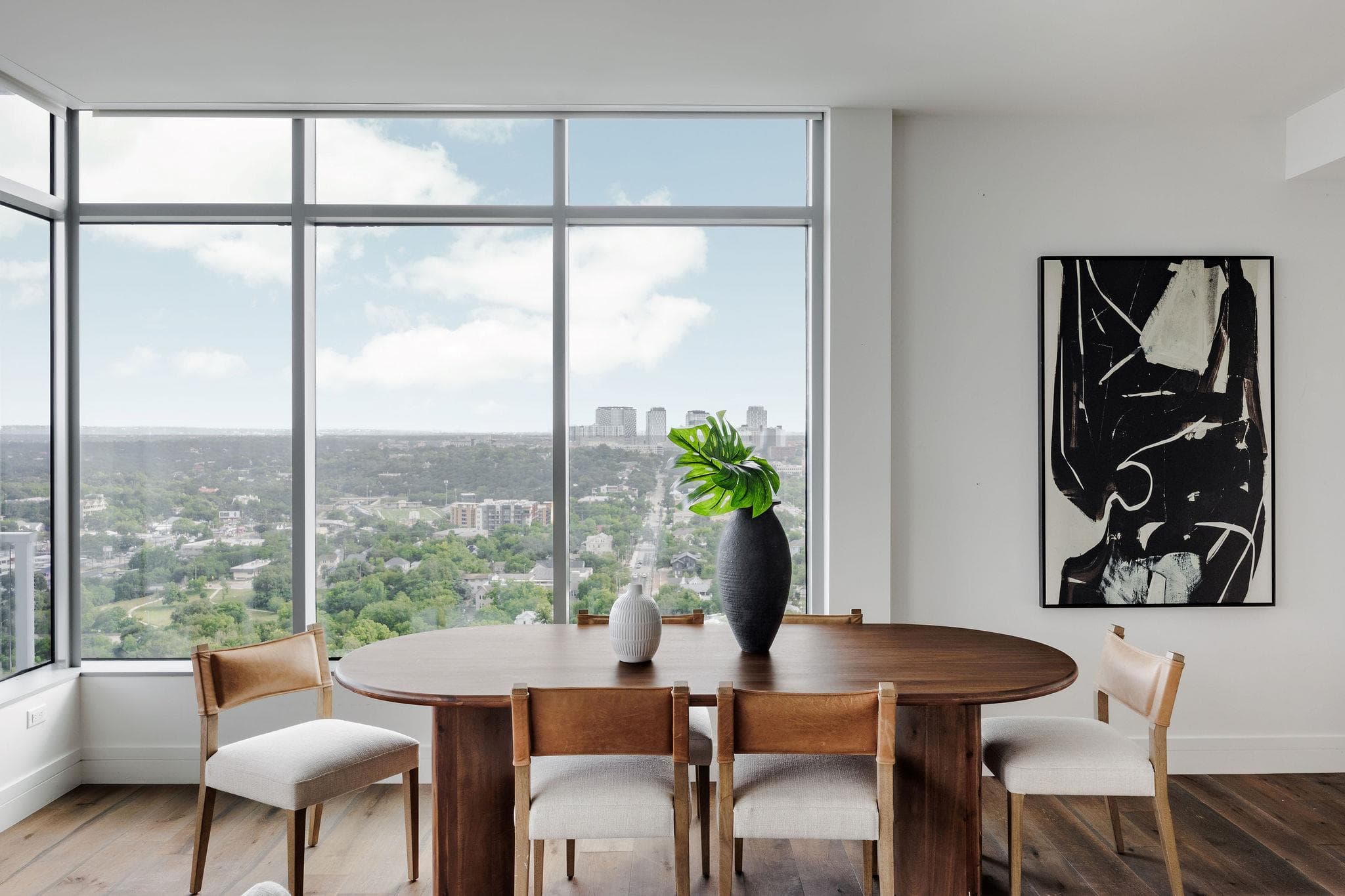 Floor-to-ceiling windows frame a commanding city