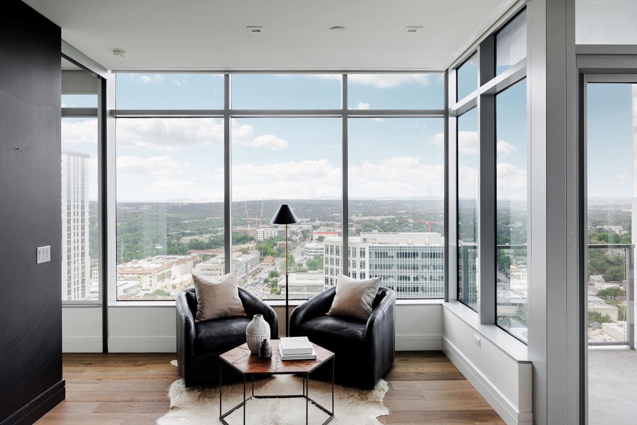 Floor-to-ceiling windows frame a commanding citys