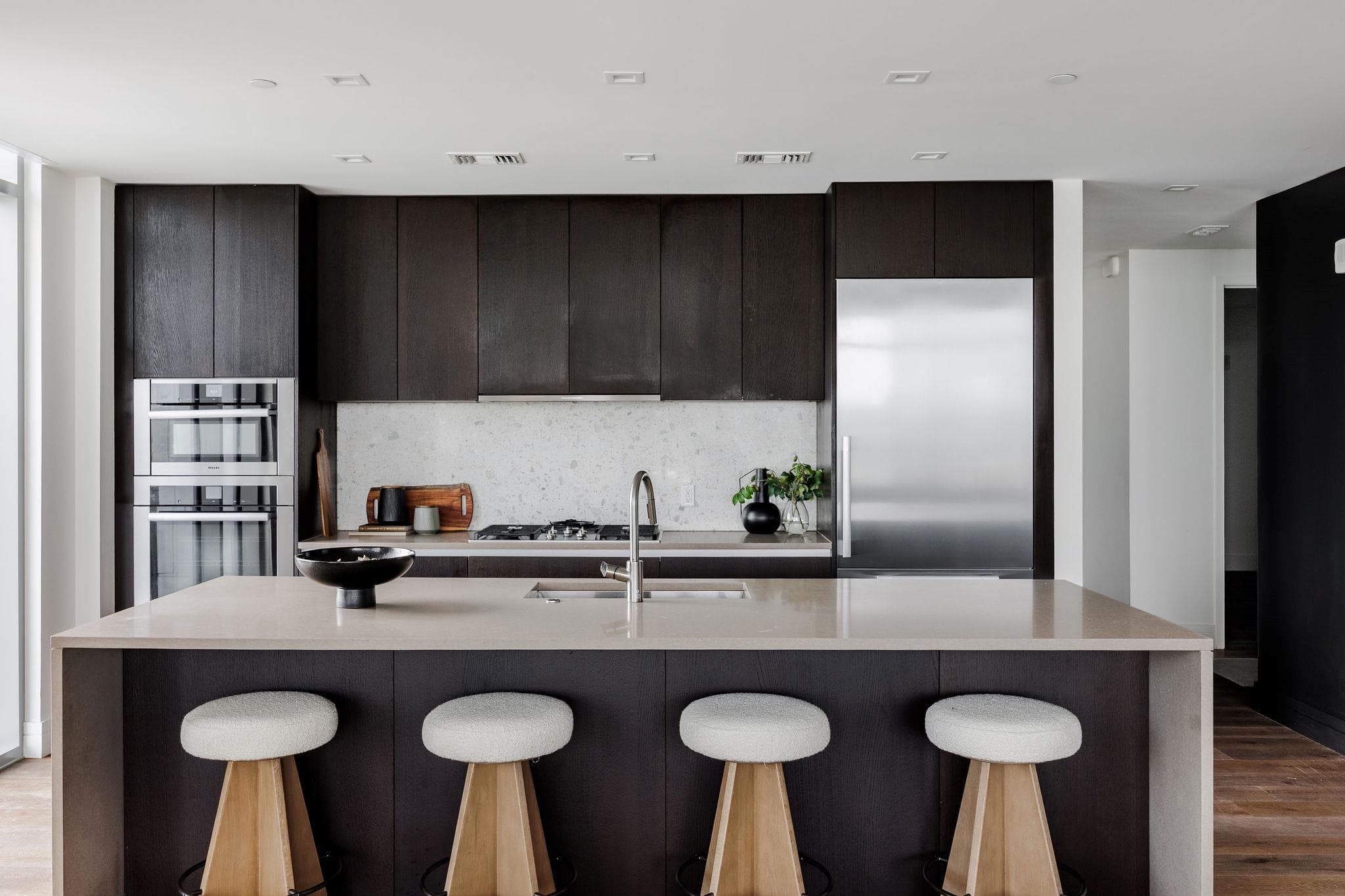 A contemporary kitchen features sleek cabinetry,
