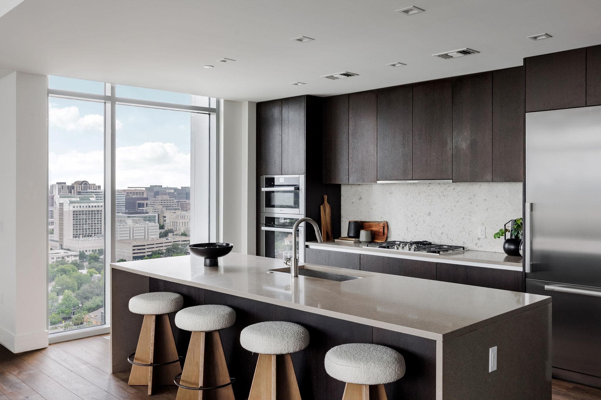 A sleek, contemporary kitchen with a grand island