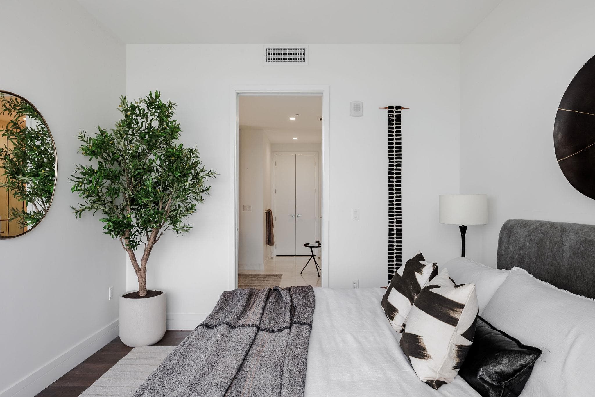 Crisp white walls and dark wood flooring define t