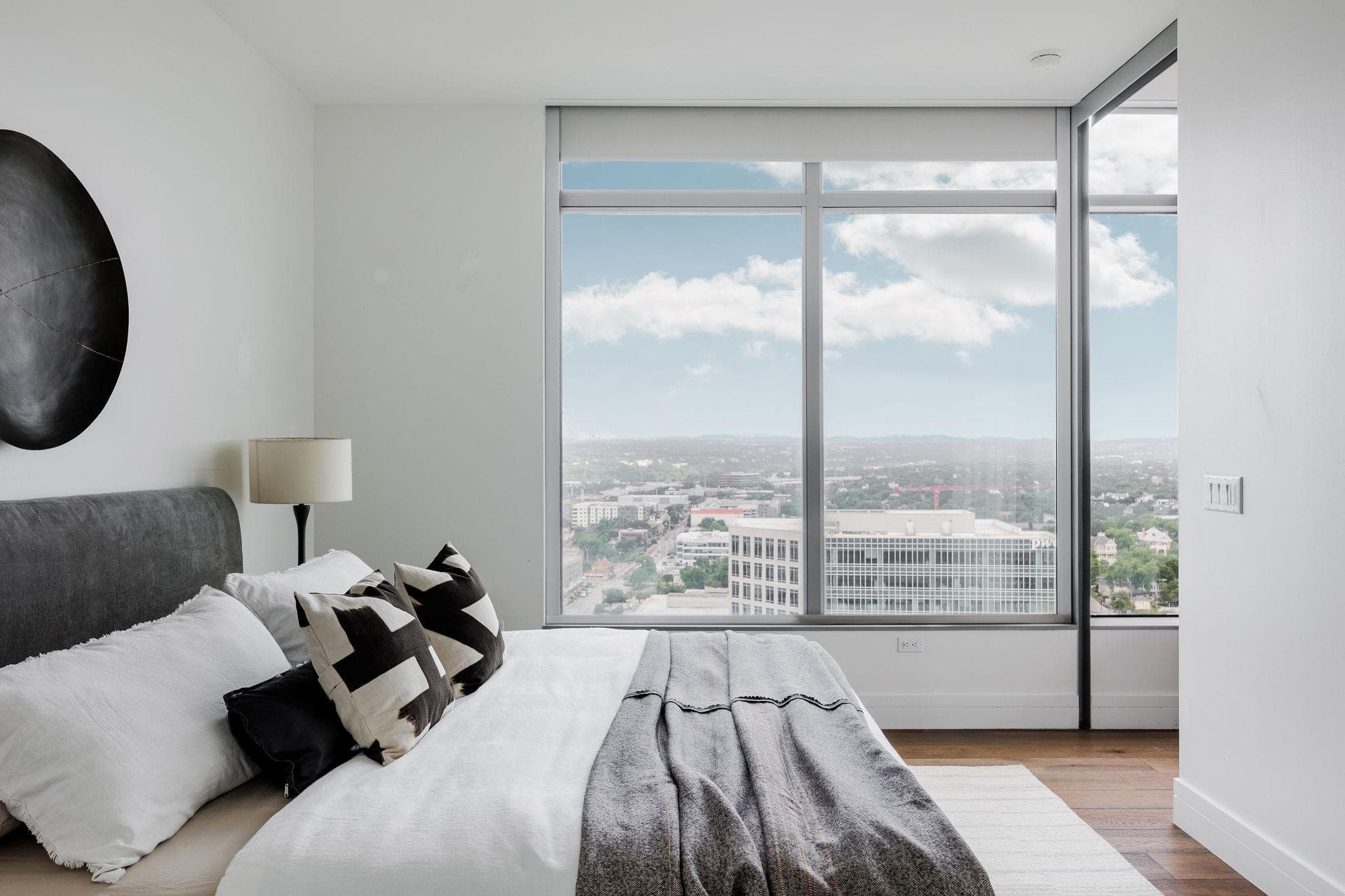 Floor-to-ceiling windows offer panoramic city vis