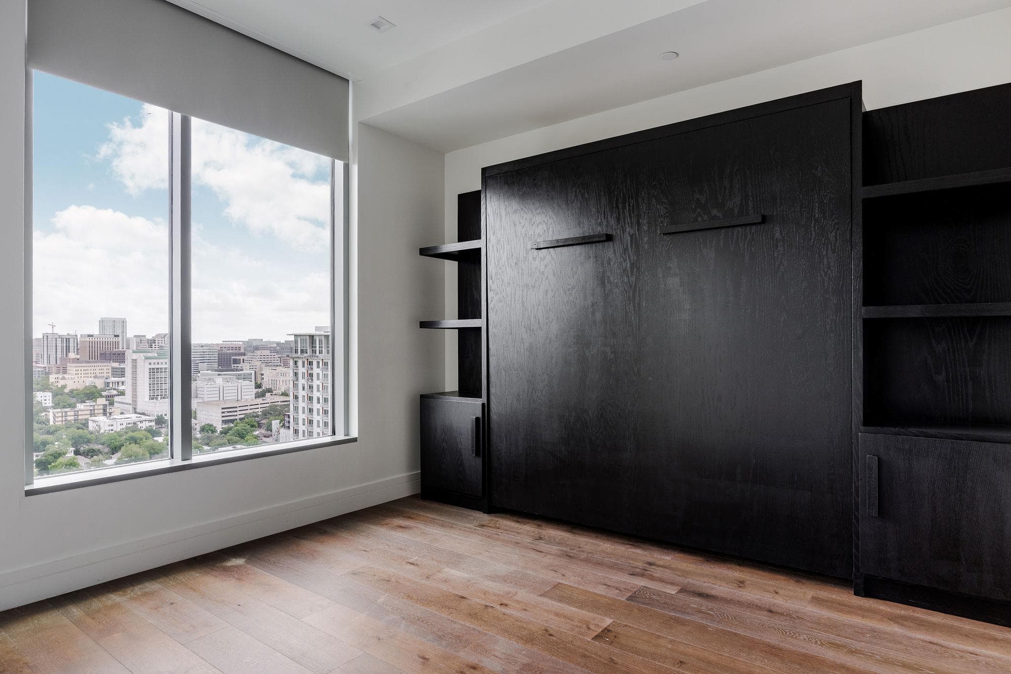 Floor-to-ceiling windows frame panoramic city vie
