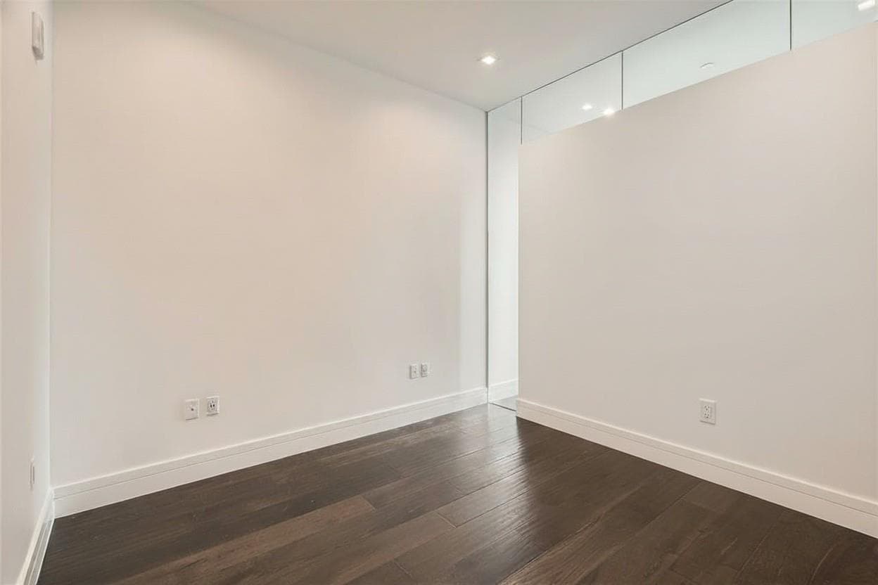 Spare room featuring dark wood finished floors an