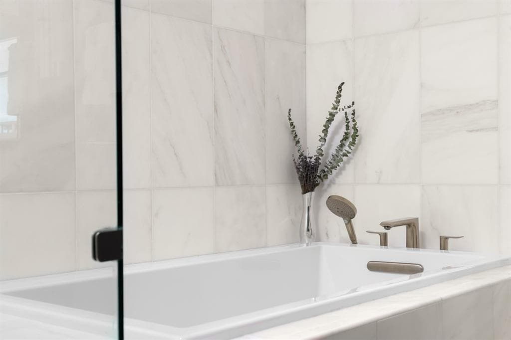 Marble bath with a soaking tub in a Fifth & West residence